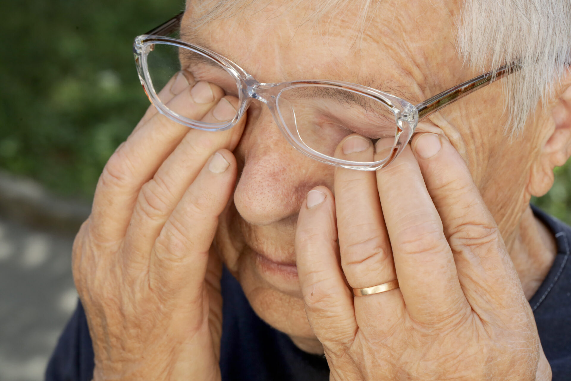 Senior caucasian woman rubbing her eyes under eyeglasses